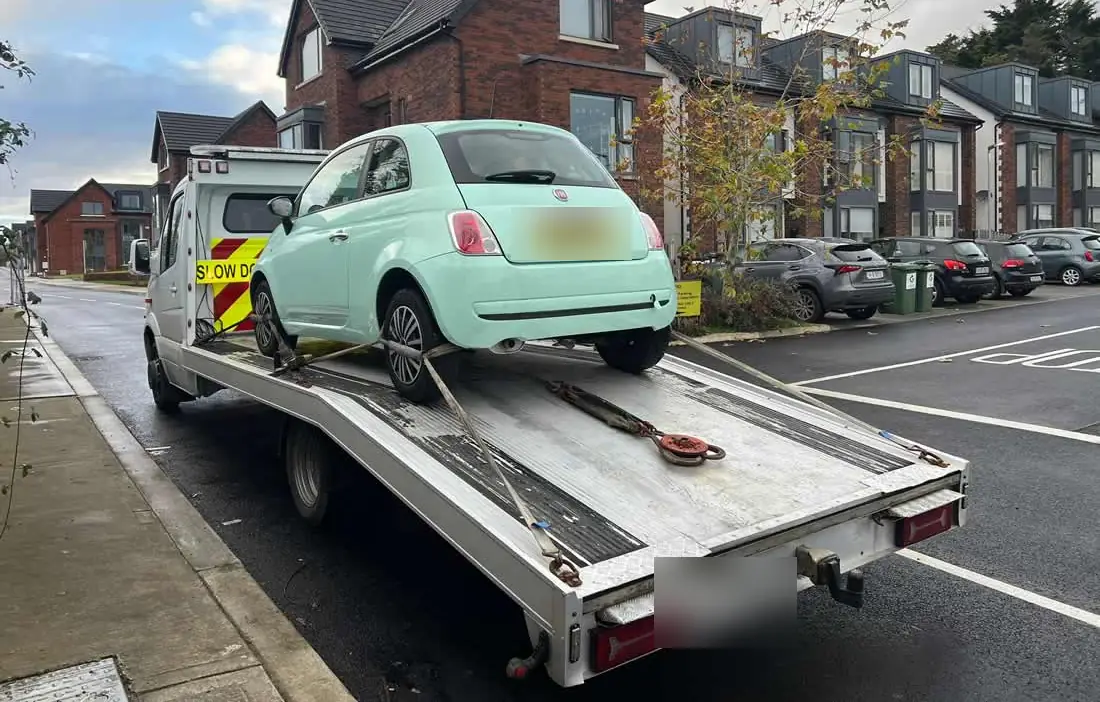 A small city car on the deck in a housing estate