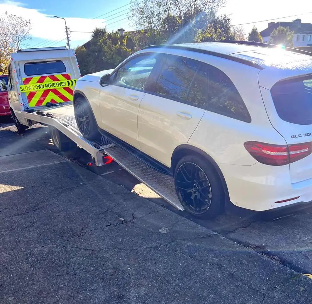 A white SUV going up the ramp in the sunshine