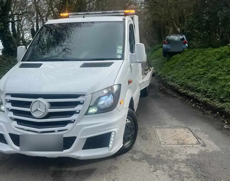 A CC Recovery Sprinter recovery truck on a narrow country lane